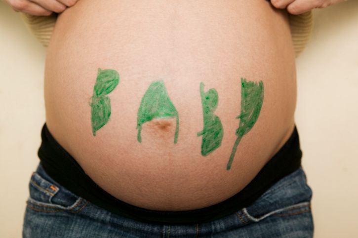woman with the word baby on her pregnant belly