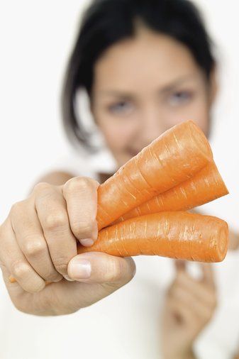 woman holding a carrot