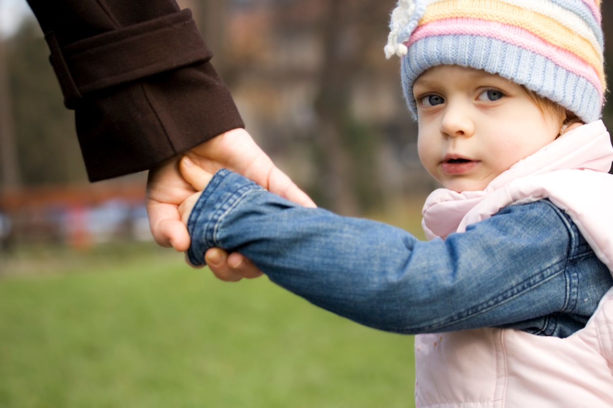 child holding parents hand