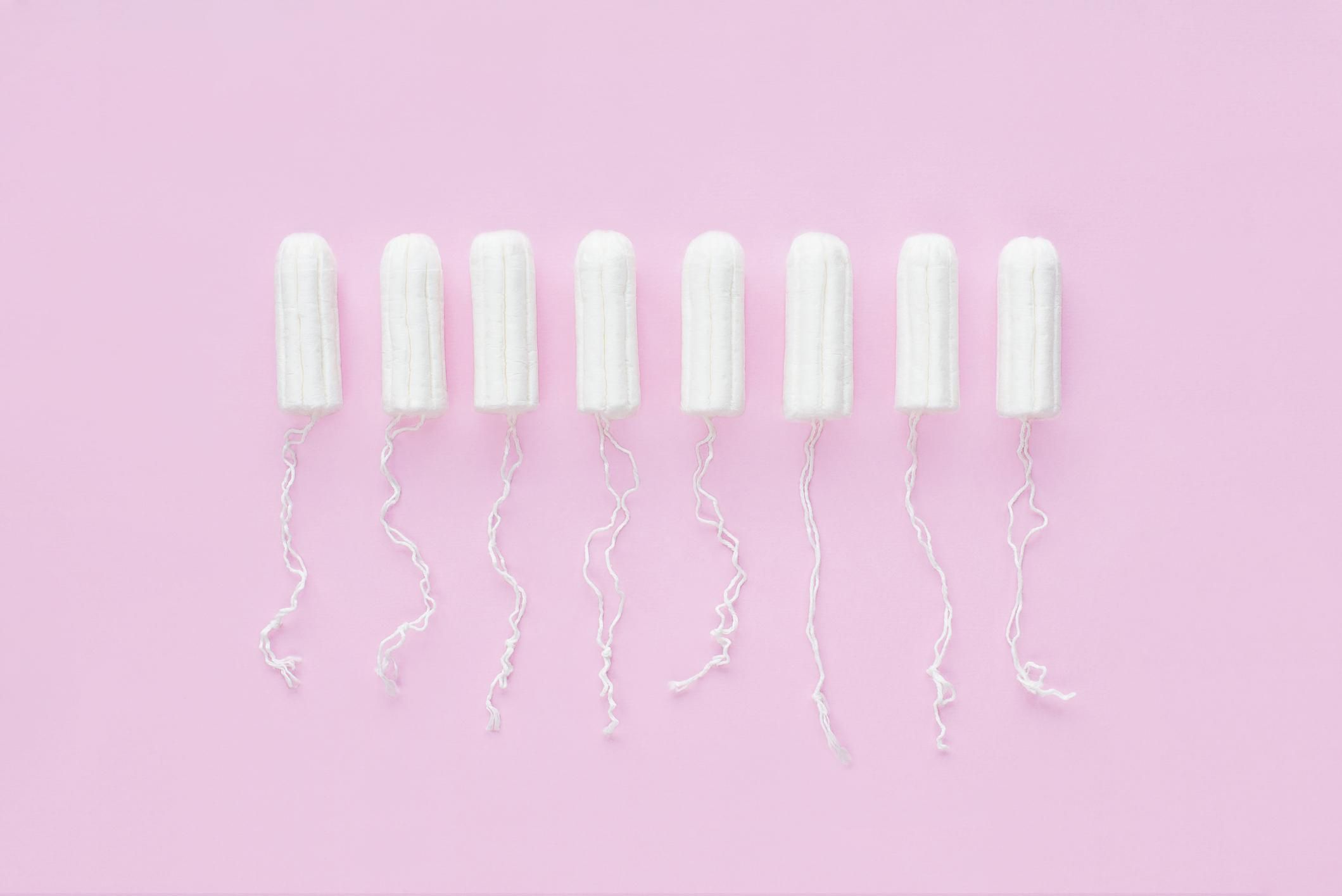 Menstrual period concept. Woman hygiene protection. Cotton tampons on pink background.