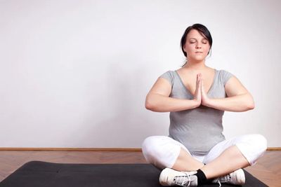 overweight woman practicing yoga