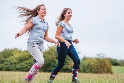 teens running in a field