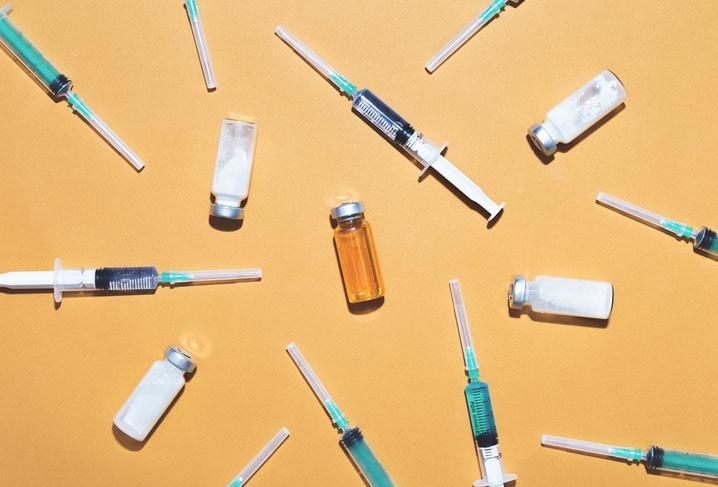 Syringes are filled with injection and medical vaccine bottles