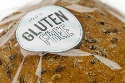 "100% Gluten Free" sticker on a loaf of brown seeded bread