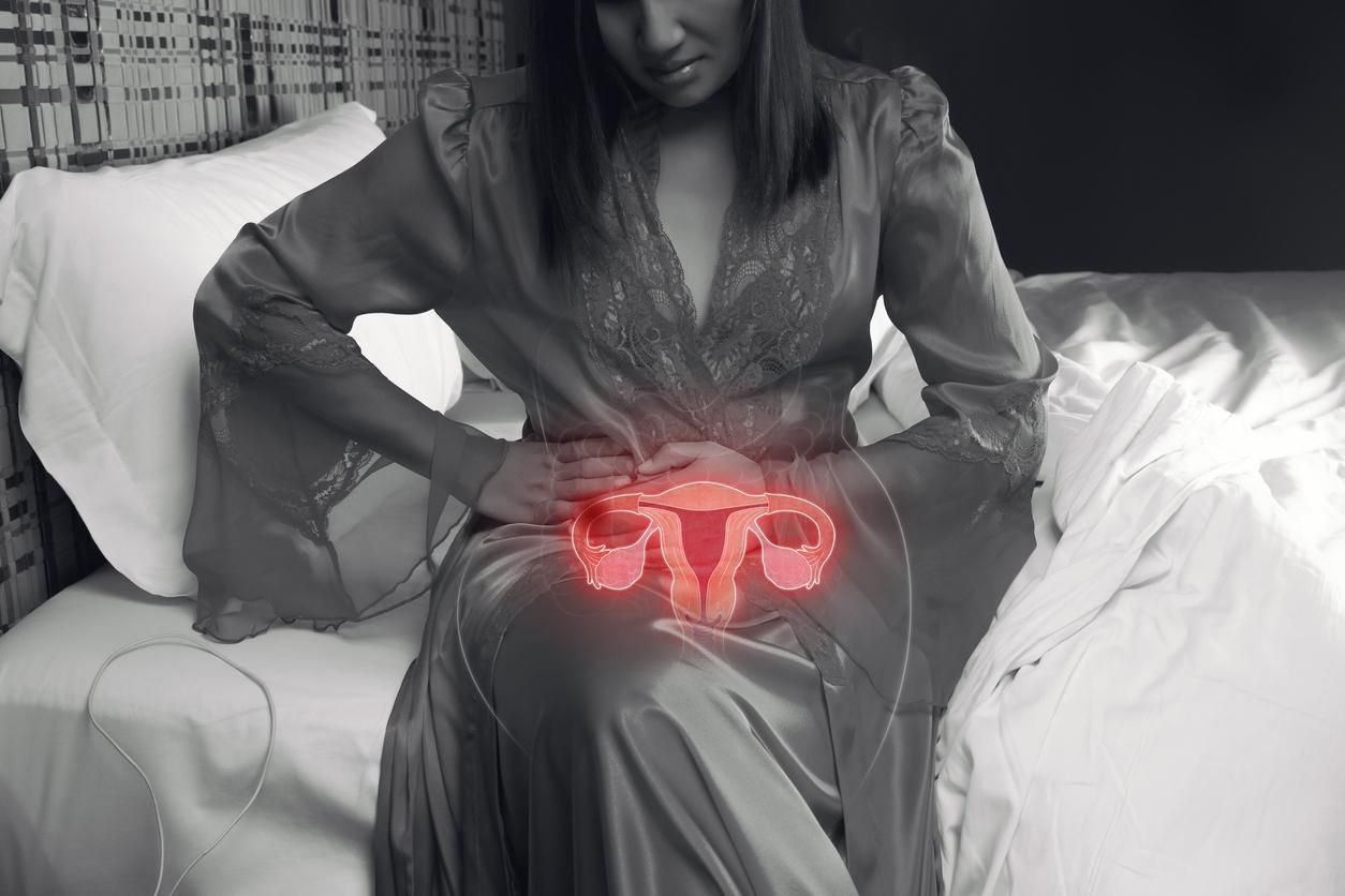Woman holding her stomach with pelvic pain