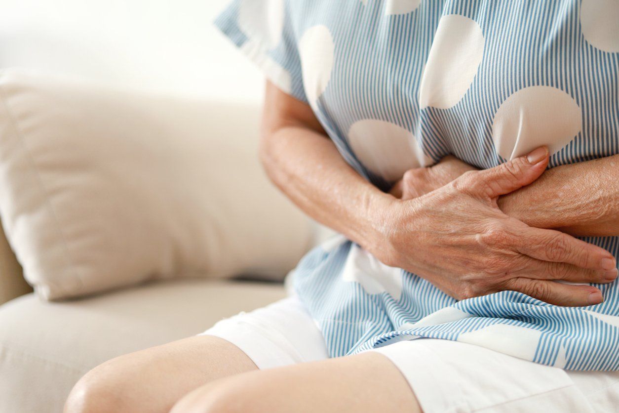 woman having painful stomachache from constipation