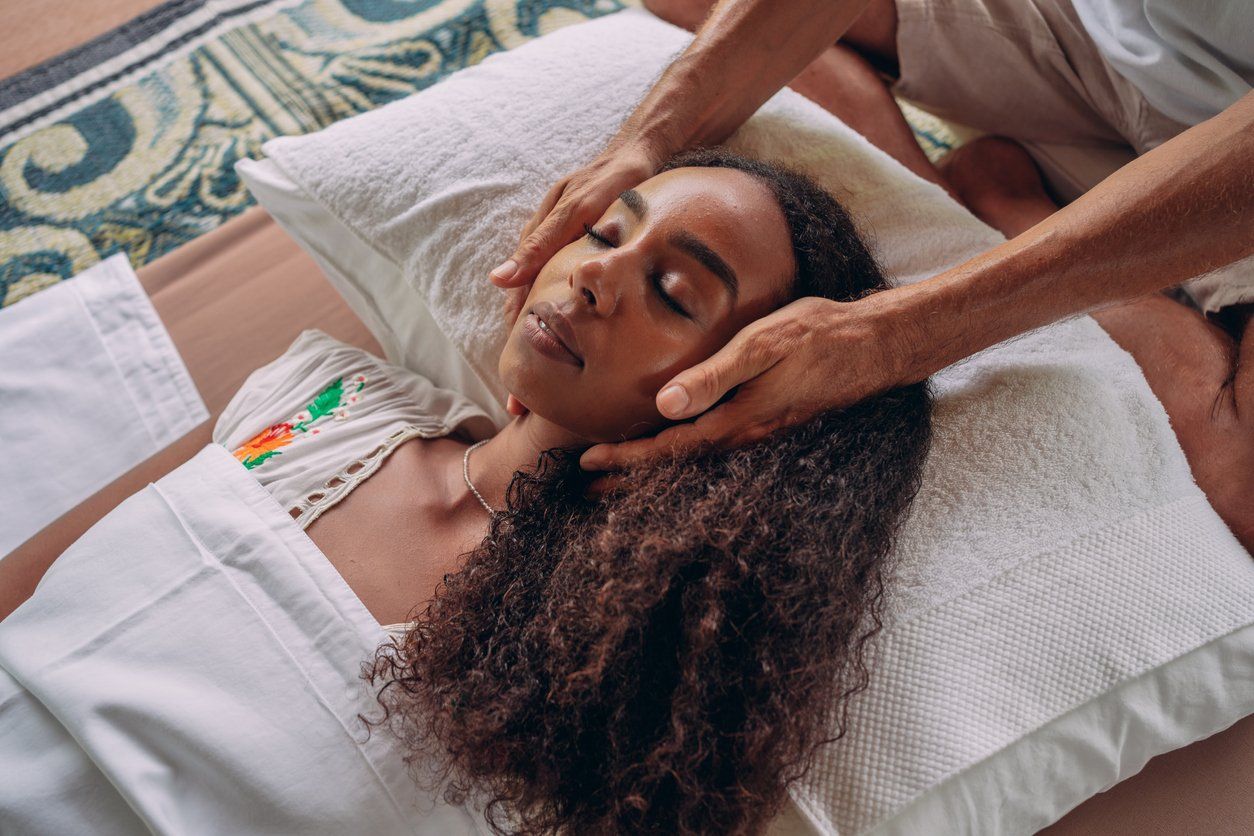 Woman having reiki healing treatment
