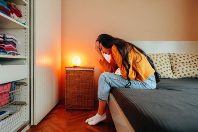 Woman with endometriosis pain staying home