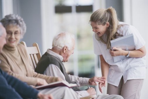 nurse talking with a man in a nursing home