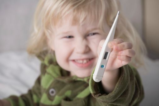 child holding a thermometer
