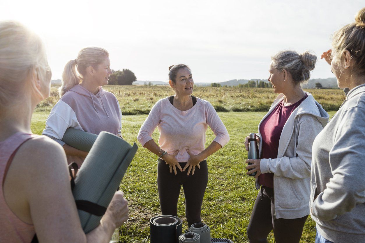 Group of mature women doing Yoga outdoors