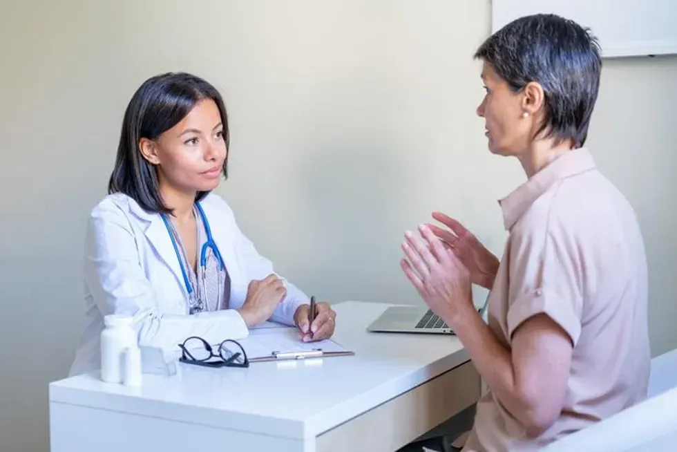 therapist listening to middle-aged female patient asking about Vaginal Atrophy