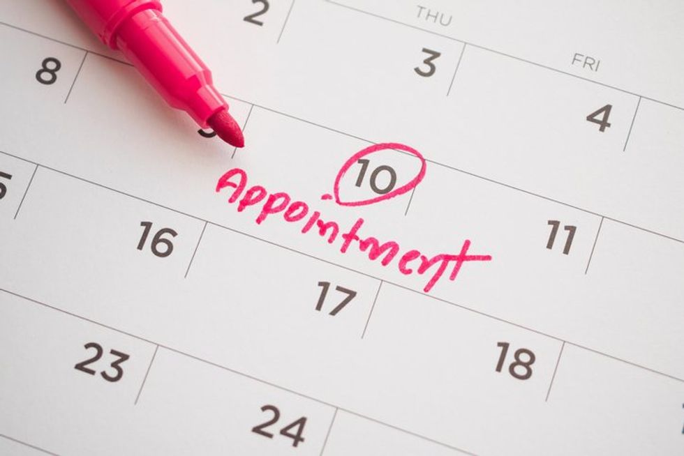 important appointment schedule write on white calendar page date close up