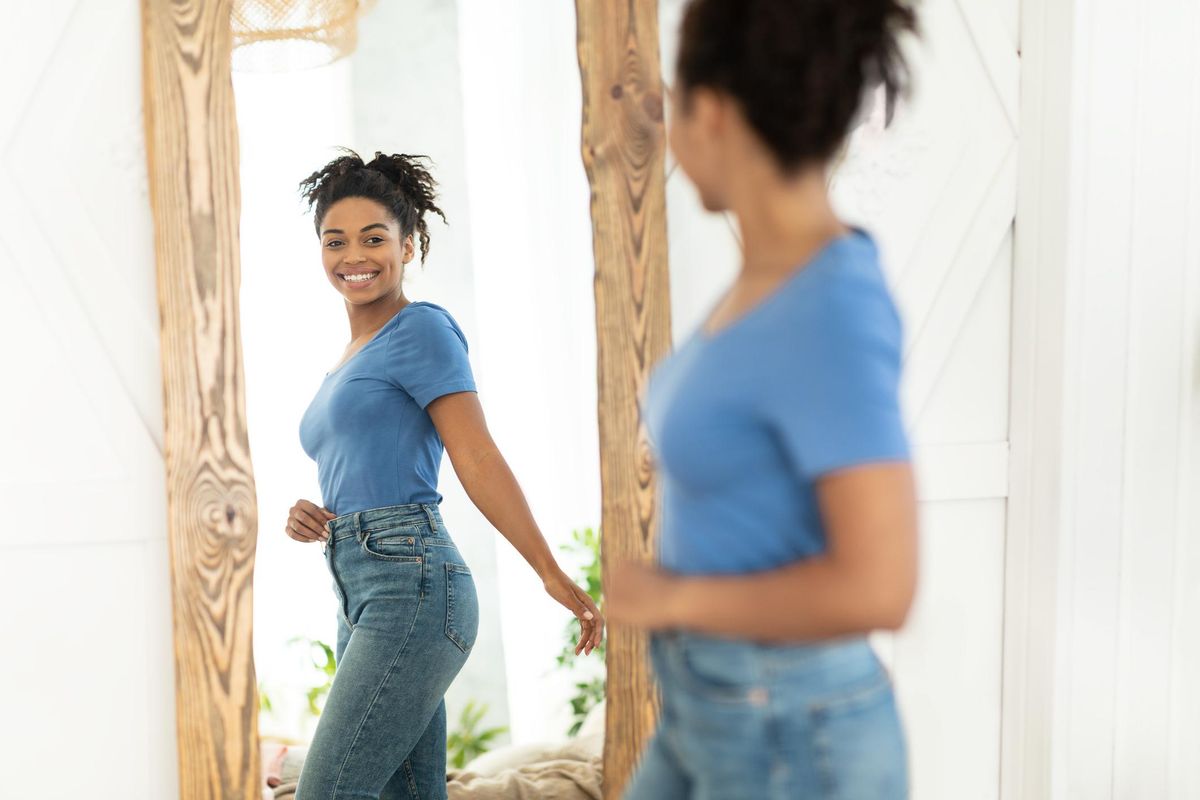 Joyful African American Girl After Slimming Looking In Mirror