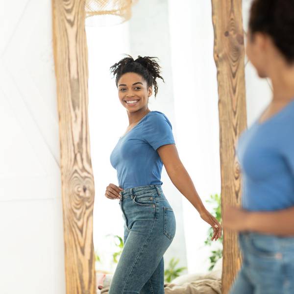 Joyful African American Girl After Slimming Looking In Mirror