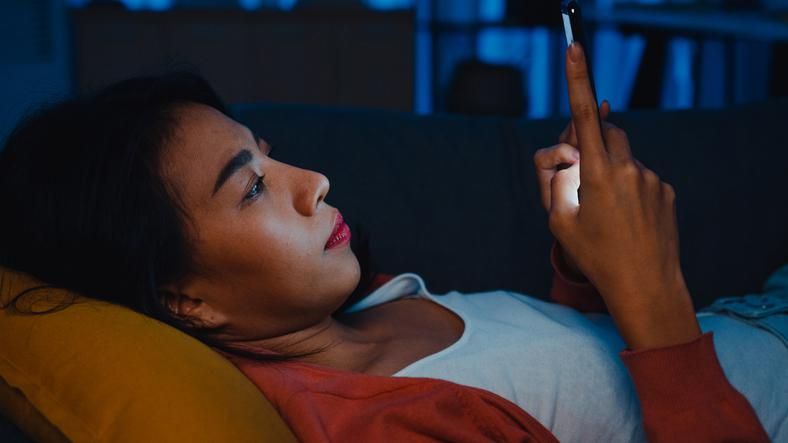 lady use smartphone sleep in bed at home feel boring and scrolling
