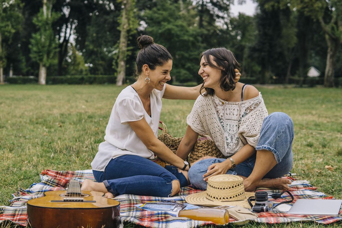 Lesbian couple relaxing outdoors in a park