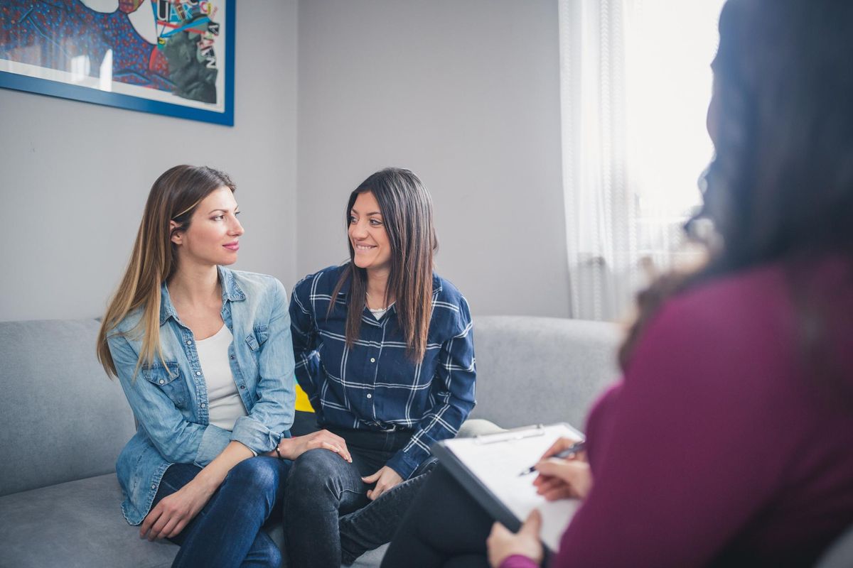 Lesbian couple Sitting in the living room with a sex therapist