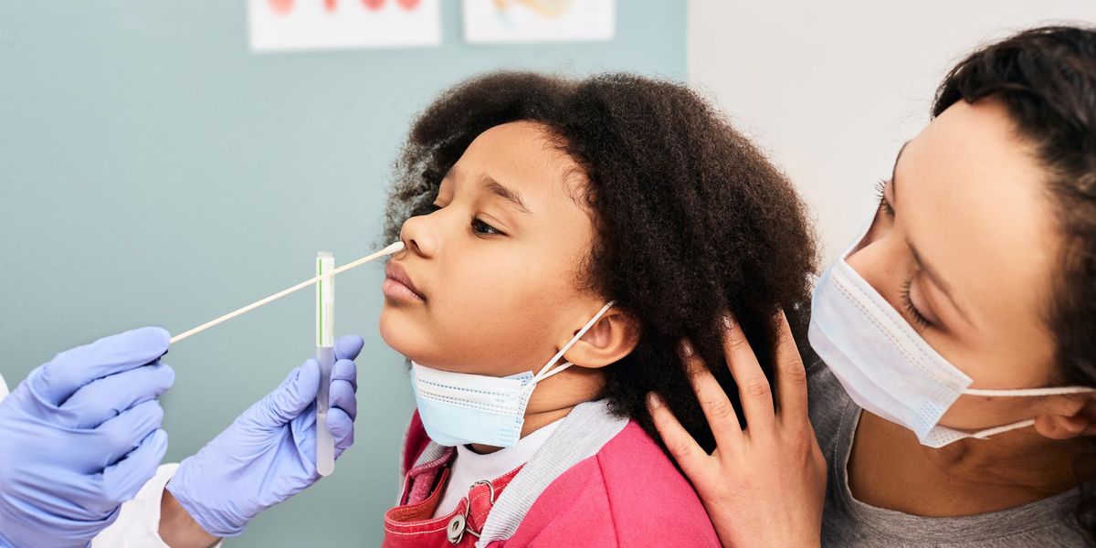 little girl with her mother during PCR test of COVID-19 in a medical lab