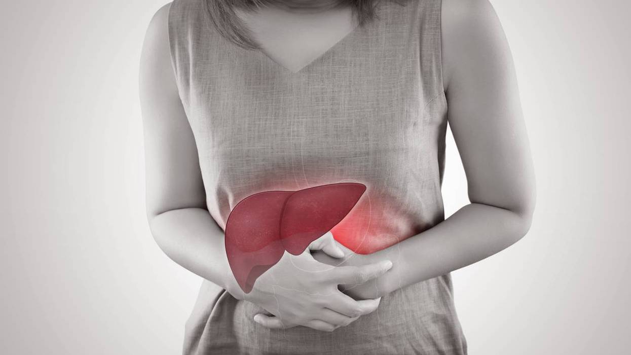 Liver On Woman's Body Against Gray Background
