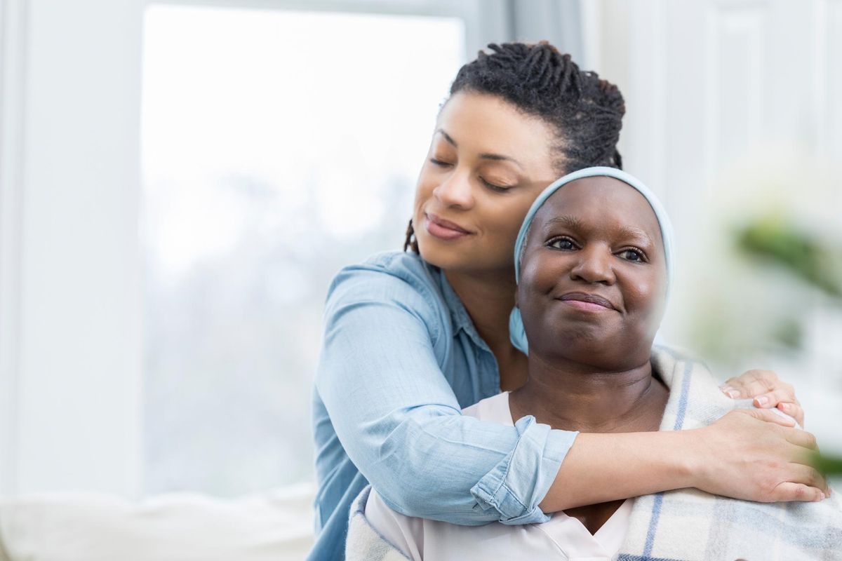 Loving daughter embraces aging mother
