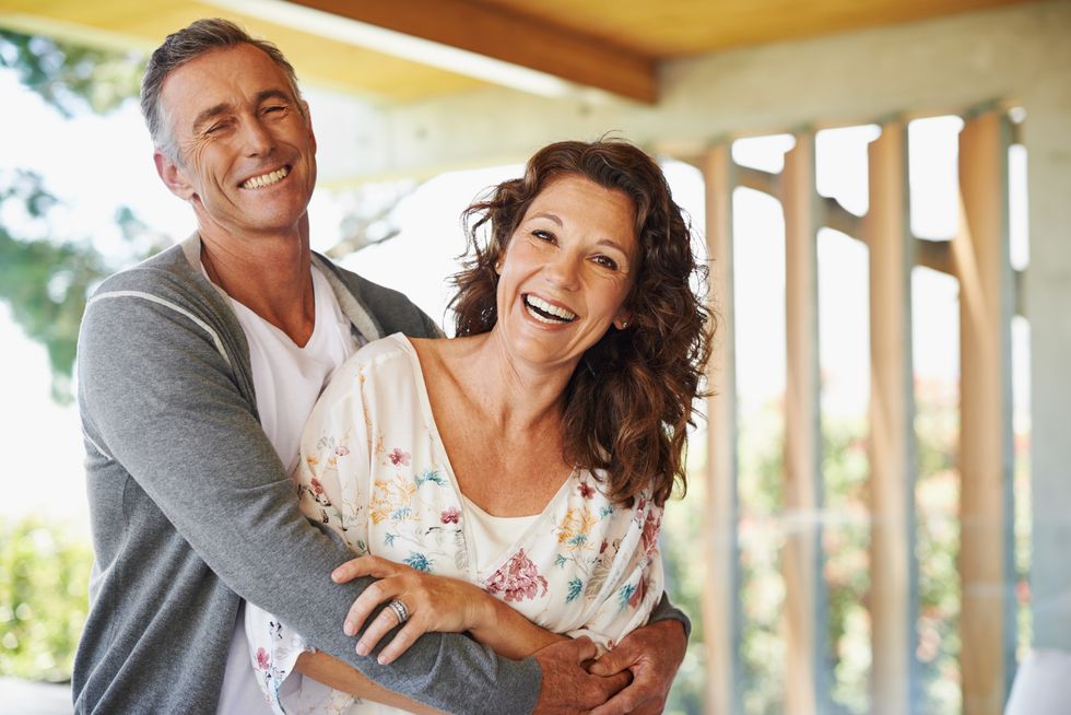 loving mature man embracing his wife with a smile