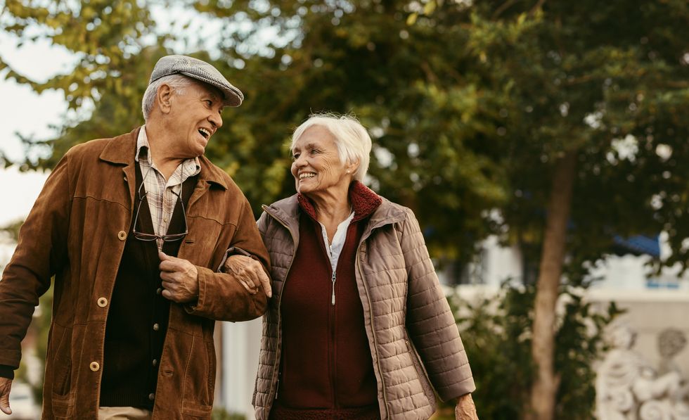 Loving senior couple enjoy a walk together on a winter day.