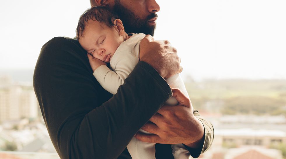 Man carrying his sleeping son