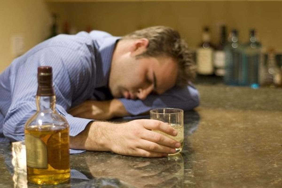 man drinking at a bar