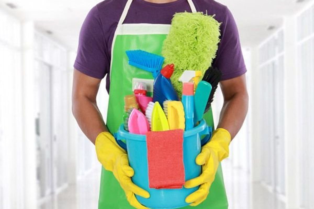 man holding cleaning supplies