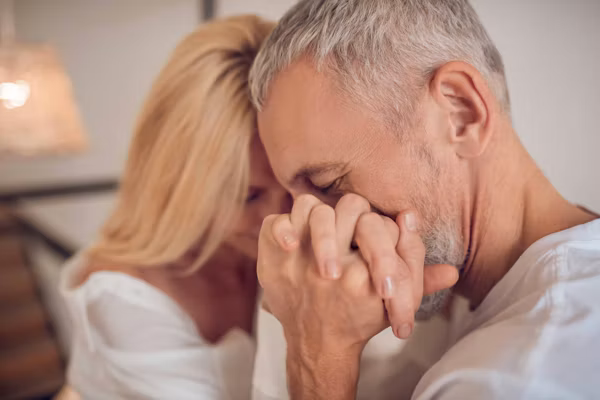 Man holding woman's hand