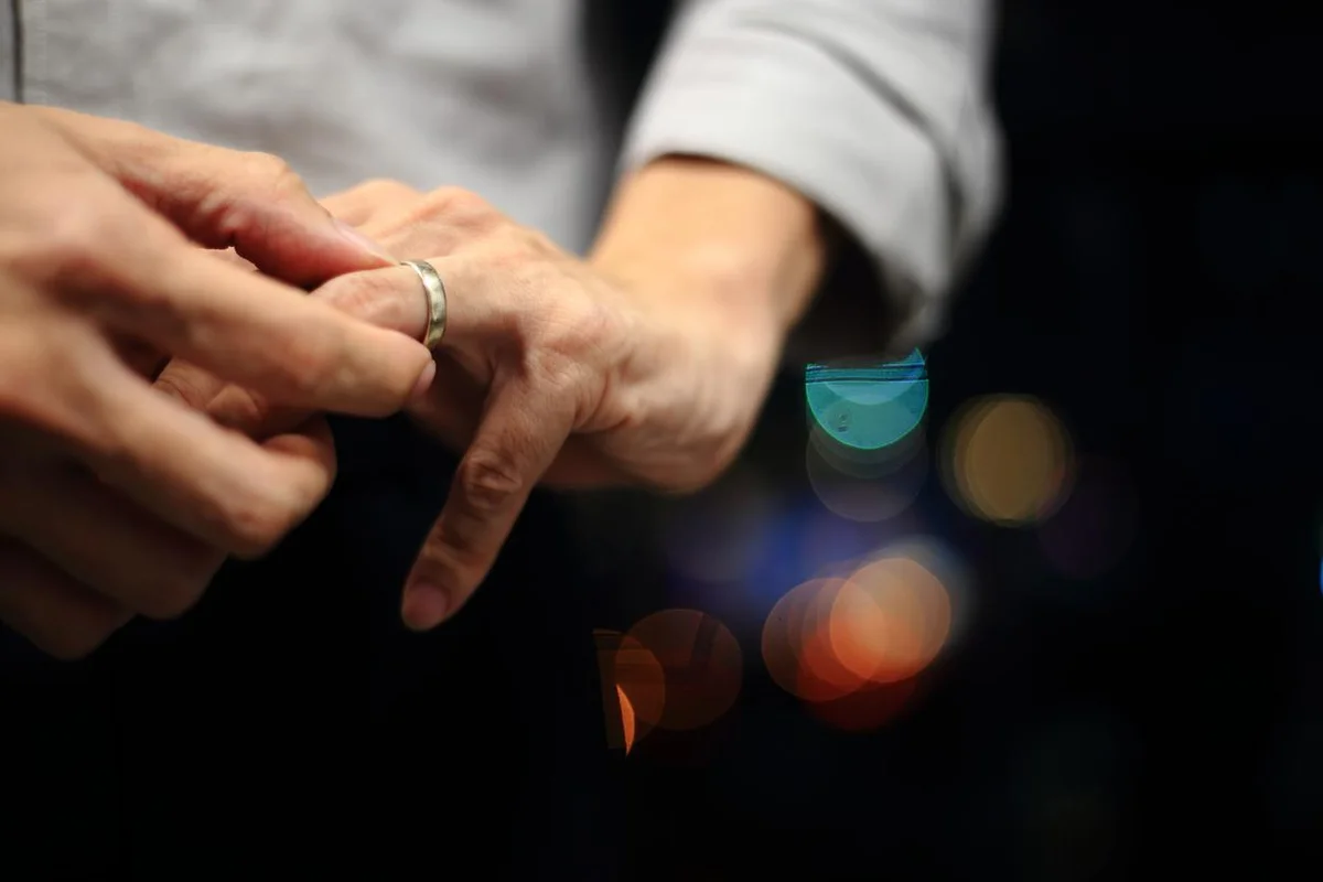 man putting on wedding ring