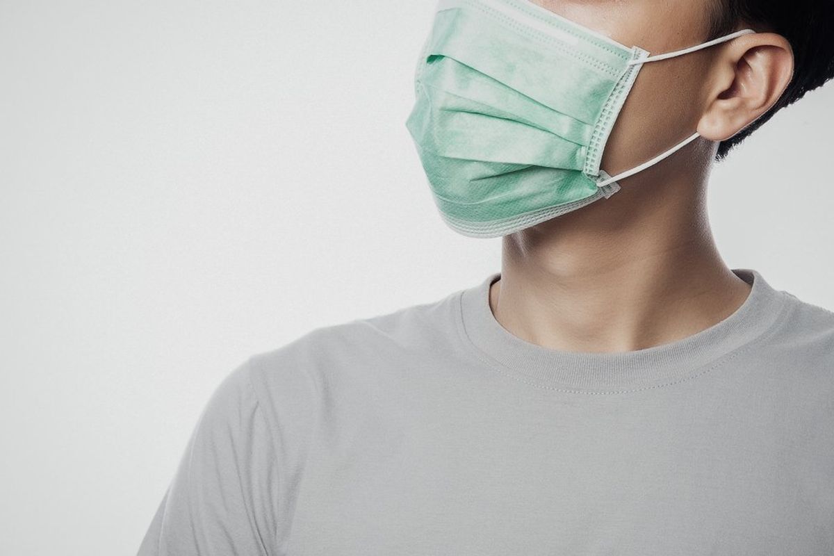 Man wearing hygienic mask to prevent infection