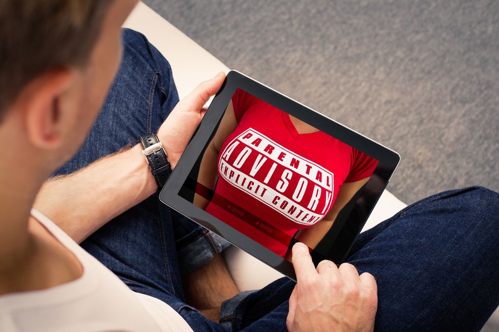 Man with porn addiction looking at adults website on tablet