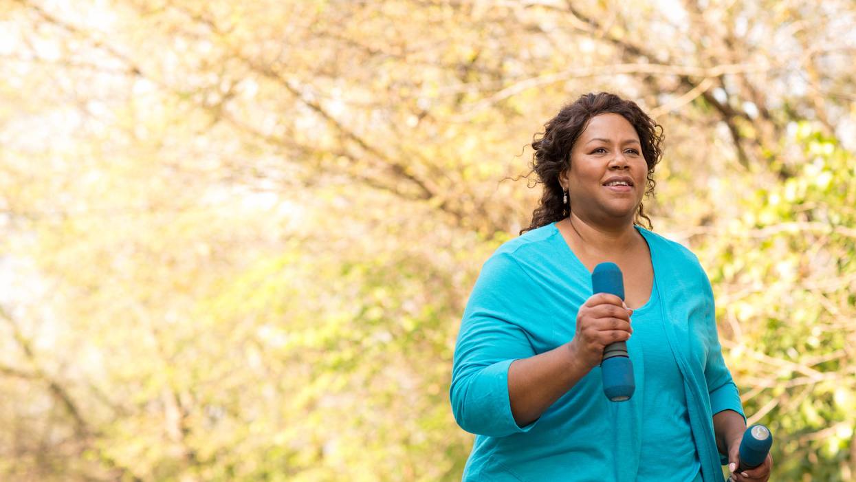 Mature African American woman smiling and exercising