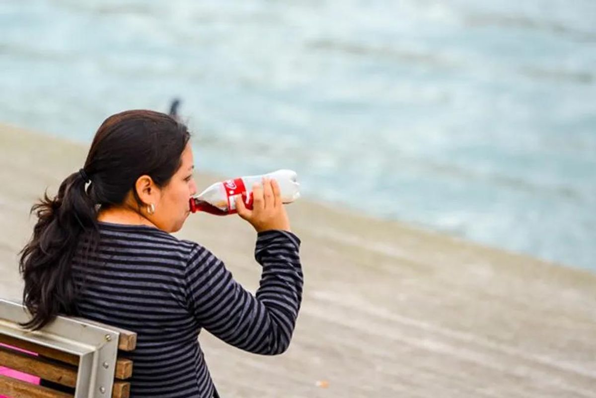 mature woman drinking soda
