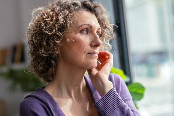 mature woman looking forwards near the window