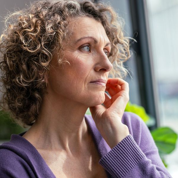 mature woman looking forwards near the window