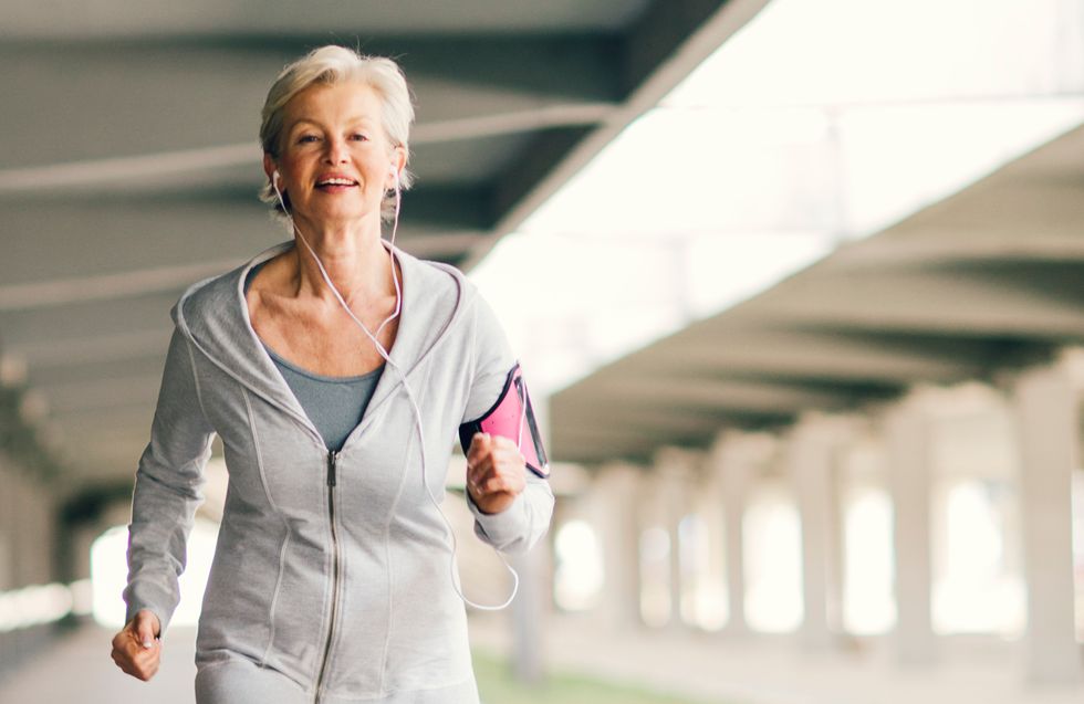 Mature Woman Running Outdoors in the city.