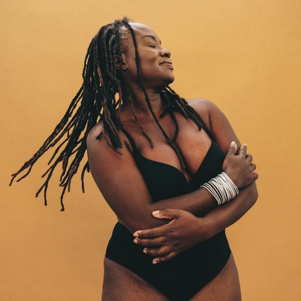 Mature woman with dreadlocks embracing her natural and ageing body