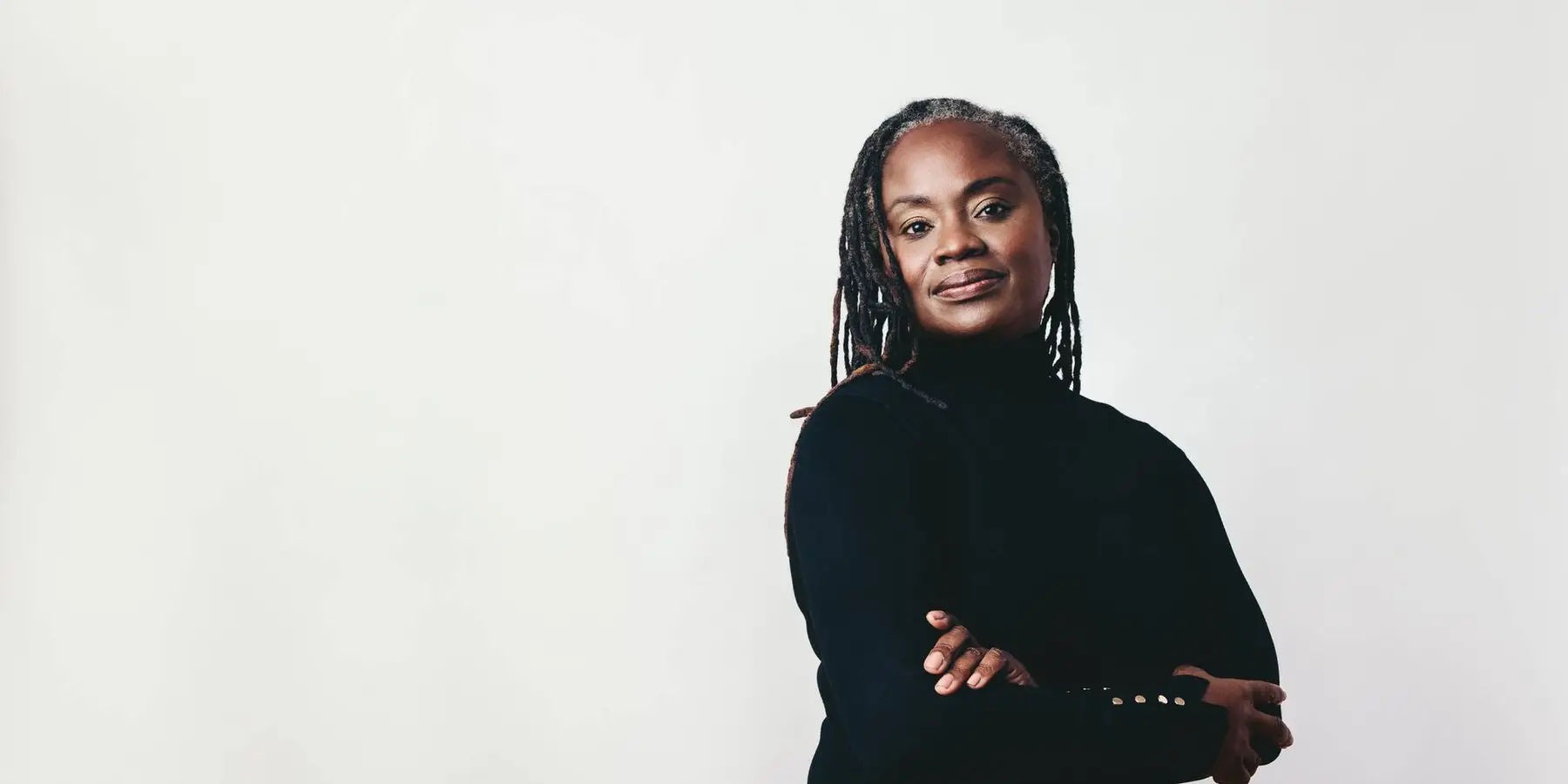 Mature woman with dreadlocks looking at the camera