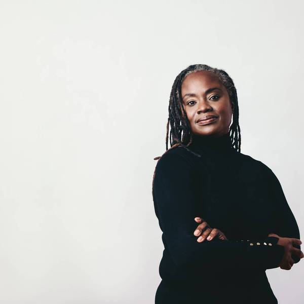 Mature woman with dreadlocks looking at the camera