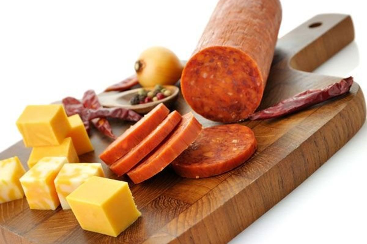meats and cheeses on a cutting board