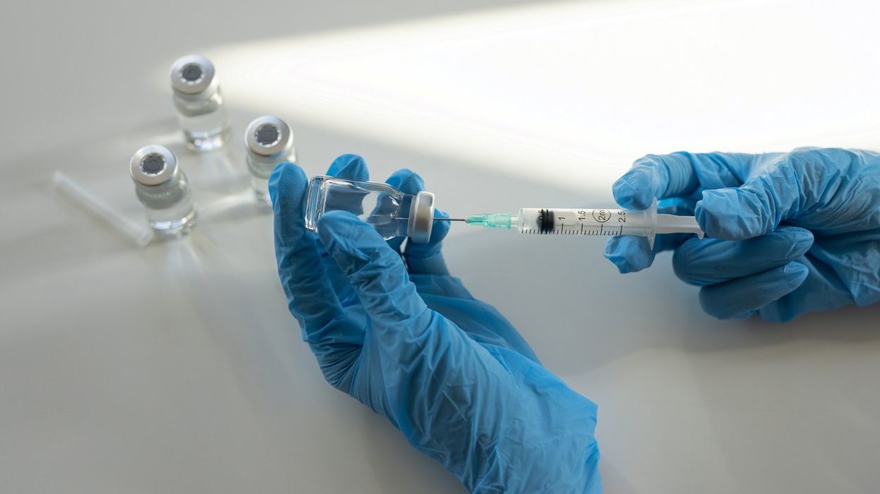 Medical person preparing to injection of medical vaccine or treatment.