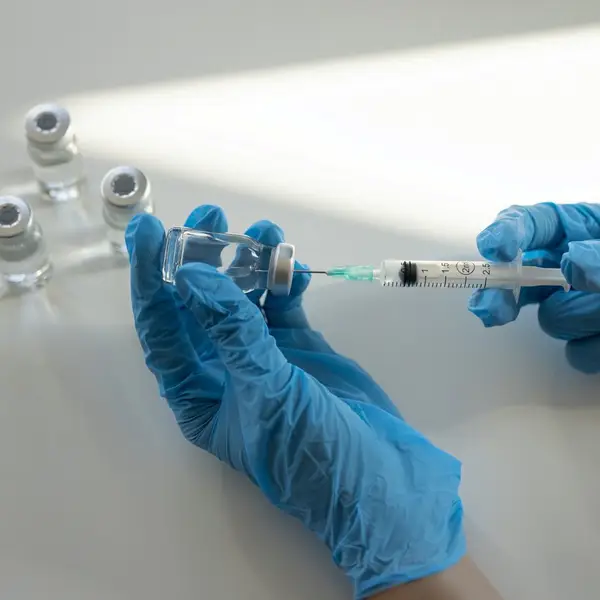 Medical person preparing to injection of medical vaccine or treatment.