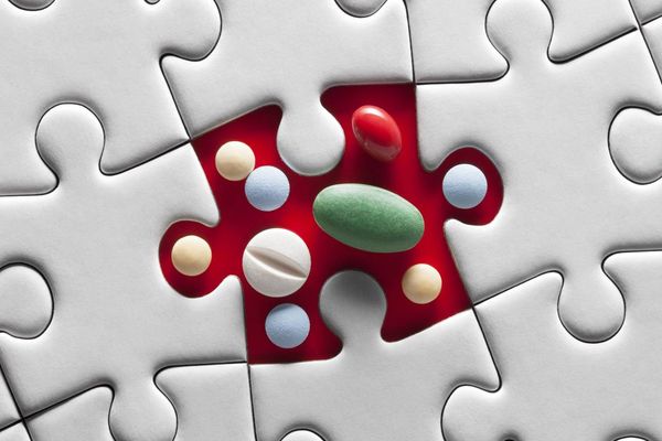 Medical pills on puzzle piece.