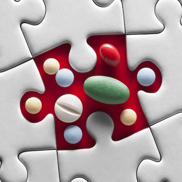 Medical pills on puzzle piece.