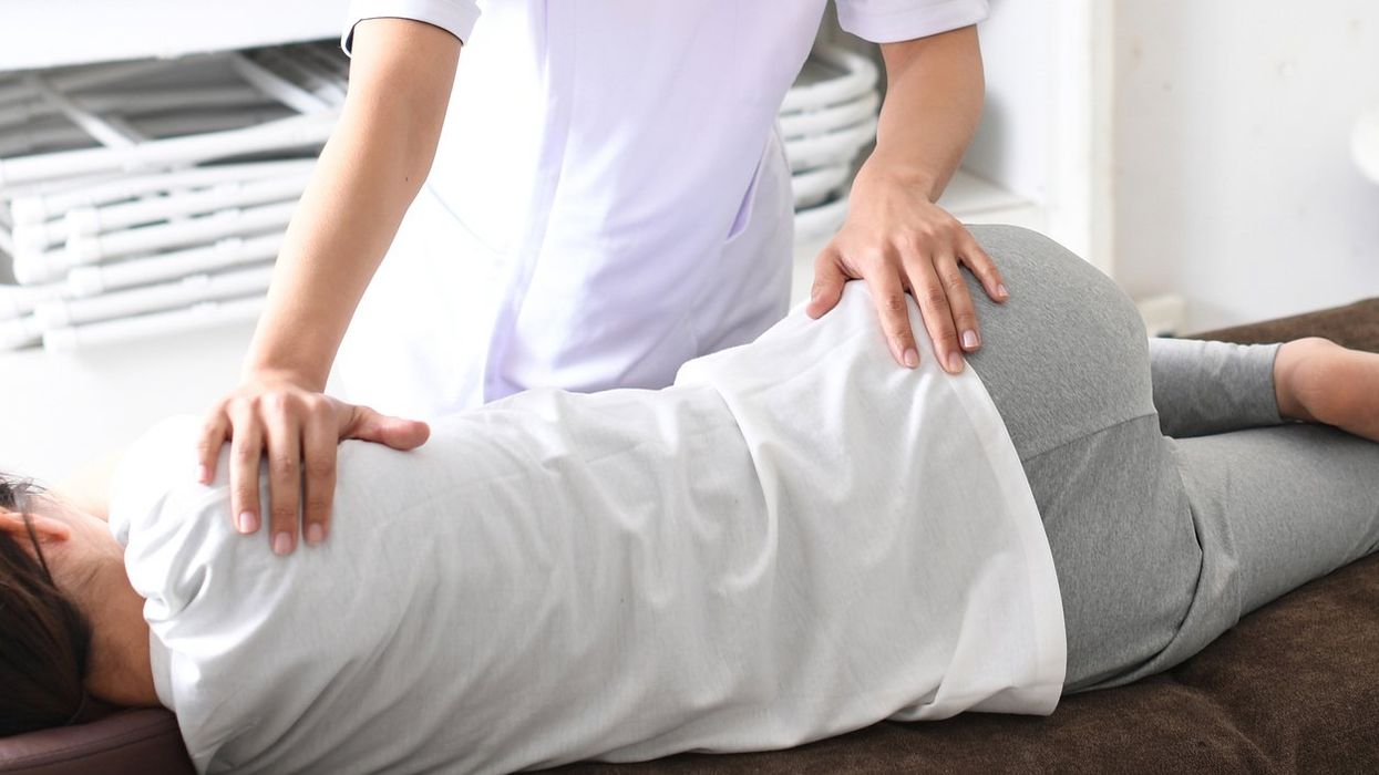 medical worker and a female patient performing pelvic correction surgery