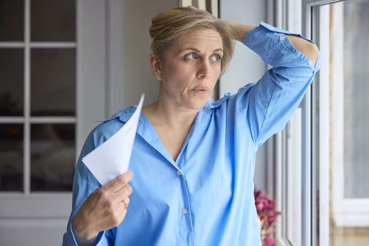 Menopausal Mature Woman Having Hot Flash At Home