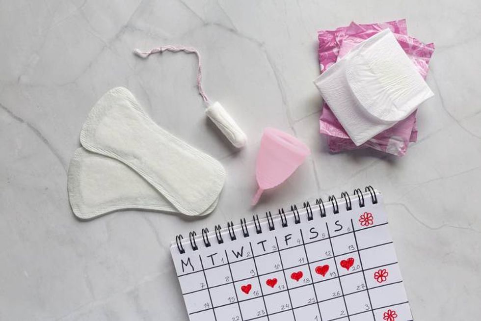 Menstrual calendar with sanitary napkins, tampons, menstrual cup
